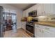 Bright kitchen with stainless steel appliances, light colored cabinets, and granite countertops, perfect for the inspired home chef at 814 Sunny Field Ln, Lawrenceville, GA 30043