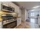 Modern kitchen showcasing stainless steel appliances, granite counters, and a view into the adjacent Gathering room at 814 Sunny Field Ln, Lawrenceville, GA 30043