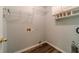Laundry room with cabinets, shelves, and wood-look flooring at 814 Sunny Field Ln, Lawrenceville, GA 30043