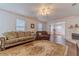 Cozy living room featuring comfortable seating, fireplace, and an arched entrance to another well-lit living area at 814 Sunny Field Ln, Lawrenceville, GA 30043