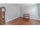 Cozy living room featuring hardwood floors, fresh paint, and a bench beside a grandfather clock at 814 Sunny Field Ln, Lawrenceville, GA 30043