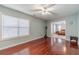 Living room with large window, ceiling fan, and hardwood floors at 814 Sunny Field Ln, Lawrenceville, GA 30043
