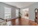 Bright living room with hardwood floors, large windows, and view to the entry, dining room, and staircase at 814 Sunny Field Ln, Lawrenceville, GA 30043