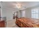 The primary bedroom features ample natural light from windows, a ceiling fan and comfortable carpet flooring at 814 Sunny Field Ln, Lawrenceville, GA 30043