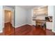 Office featuring built-in shelves, desk, and hardwood floors at 814 Sunny Field Ln, Lawrenceville, GA 30043