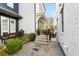 Landscaped backyard featuring a stone patio, grill, and stairs leading to upper level at 2057 Telfair Cir, Atlanta, GA 30324