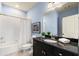 Bathroom features a white tile shower/tub, granite countertop and black cabinets at 2057 Telfair Cir, Atlanta, GA 30324