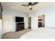 A Primary bedroom featuring a ceiling fan, television, and a view into an ensuite bathroom at 2057 Telfair Cir, Atlanta, GA 30324