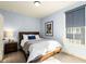 Bedroom boasts a full-sized bed, a dark wood nightstand, and a window with closed shades at 2057 Telfair Cir, Atlanta, GA 30324