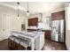 Kitchen with dark wood cabinetry, granite counters, a center island, and stainless steel appliances at 2057 Telfair Cir, Atlanta, GA 30324