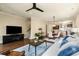 Bright living room with hardwood floors, ceiling fan, and open layout to the kitchen at 2057 Telfair Cir, Atlanta, GA 30324