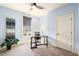 A home office features a desk, chair, potted plant, and a roller shade covered window at 2057 Telfair Cir, Atlanta, GA 30324