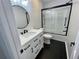 Contemporary bathroom with a white vanity, modern fixtures, and herringbone flooring at 4320 Center Hill Church Rd, Loganville, GA 30052