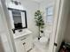 Updated bathroom with white vanity, new fixtures, and marble-look flooring at 4320 Center Hill Church Rd, Loganville, GA 30052