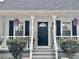 Inviting front porch with black door, white siding, and charming landscaping at 4320 Center Hill Church Rd, Loganville, GA 30052
