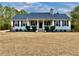 White house with gray roof, porch, and landscaping; American flag at 4320 Center Hill Church Rd, Loganville, GA 30052