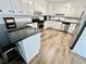 Renovated kitchen with white cabinets, granite countertops, and LVP flooring at 4320 Center Hill Church Rd, Loganville, GA 30052