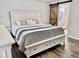 Main bedroom with king-size bed, white dresser, and barn door at 4320 Center Hill Church Rd, Loganville, GA 30052