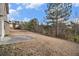 Spacious backyard with a small patio and natural landscape at 436 Margaux Way, Atlanta, GA 30349