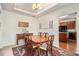 Traditional dining room with wood table, chairs, and buffet, adjacent to the kitchen at 436 Margaux Way, Atlanta, GA 30349
