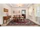 Bright dining room featuring tray ceiling, wood table, chairs, and decorative rug at 436 Margaux Way, Atlanta, GA 30349
