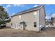 Two-story home with neutral siding and a spacious backyard with a small patio area at 436 Margaux Way, Atlanta, GA 30349