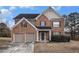 Charming two-story home with a brick facade, a two car garage, and well-maintained landscaping at 436 Margaux Way, Atlanta, GA 30349