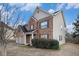 Well-maintained two-story home featuring brick and siding exterior, manicured landscaping, and attached two-car garage at 436 Margaux Way, Atlanta, GA 30349