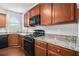 Modern kitchen features wood cabinets, granite countertops, and stainless steel appliances at 436 Margaux Way, Atlanta, GA 30349