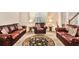 Spacious living room featuring neutral carpet, leather couches and decorative furnishings at 436 Margaux Way, Atlanta, GA 30349