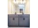 Double vanity bathroom with gray cabinets and a large mirror at 776 Clifftop Crossing, Powder Springs, GA 30127