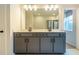 Modern bathroom with gray double vanity and large mirror at 776 Clifftop Crossing, Powder Springs, GA 30127