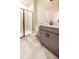Modern bathroom with gray vanity, frameless shower, and tile floors at 776 Clifftop Crossing, Powder Springs, GA 30127