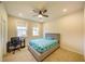 Sunny bedroom featuring neutral carpet, a ceiling fan, and two bright windows at 776 Clifftop Crossing, Powder Springs, GA 30127