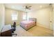 Bright bedroom featuring a ceiling fan, carpet, and ample natural light from two windows at 776 Clifftop Crossing, Powder Springs, GA 30127
