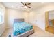 Comfortable bedroom with a ceiling fan, carpet, and view of the stairwell at 776 Clifftop Crossing, Powder Springs, GA 30127