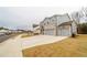 Two-story house with gray siding, stone accents, and three-car garage at 776 Clifftop Crossing, Powder Springs, GA 30127