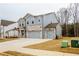 Two-story house with gray siding, stone accents, and three-car garage at 776 Clifftop Crossing, Powder Springs, GA 30127