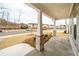 View from the front porch of a home with stone columns and a grassy lawn at 776 Clifftop Crossing, Powder Springs, GA 30127