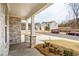 Inviting covered front porch with stone pillars and well-maintained landscaping enhances curb appeal at 776 Clifftop Crossing, Powder Springs, GA 30127