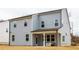Two-story house with gray siding, covered patio, and a spacious backyard at 776 Clifftop Crossing, Powder Springs, GA 30127