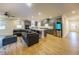 Open concept kitchen and living area with gray cabinets and hardwood floors at 776 Clifftop Crossing, Powder Springs, GA 30127