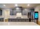 Modern kitchen with gray cabinets, quartz countertops and stainless steel appliances at 776 Clifftop Crossing, Powder Springs, GA 30127