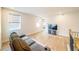 Bright living area with hardwood floors, neutral walls, and modern windows with shades, plus a comfortable gray couch at 776 Clifftop Crossing, Powder Springs, GA 30127