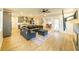 Living room with sectional sofa, hardwood floors, fireplace, and access to kitchen at 776 Clifftop Crossing, Powder Springs, GA 30127