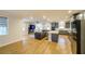 Open concept living area with kitchen, island, hardwood floors, and fireplace at 776 Clifftop Crossing, Powder Springs, GA 30127