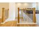 The staircase landing features hardwood floors and a contrasting black and wooden railing at 776 Clifftop Crossing, Powder Springs, GA 30127