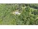 Home nestled in a verdant canopy, featuring a winding driveway and a detached garage, exemplifying private countryside living at 764 Little Vine Church Rd, Villa Rica, GA 30180
