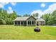 Expansive backyard featuring lush green grass, a modern home design, and a screened-in porch, perfect for outdoor relaxation at 764 Little Vine Church Rd, Villa Rica, GA 30180