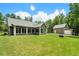 Expansive backyard featuring lush lawn, screened-in porch, and detached garage at 764 Little Vine Church Rd, Villa Rica, GA 30180